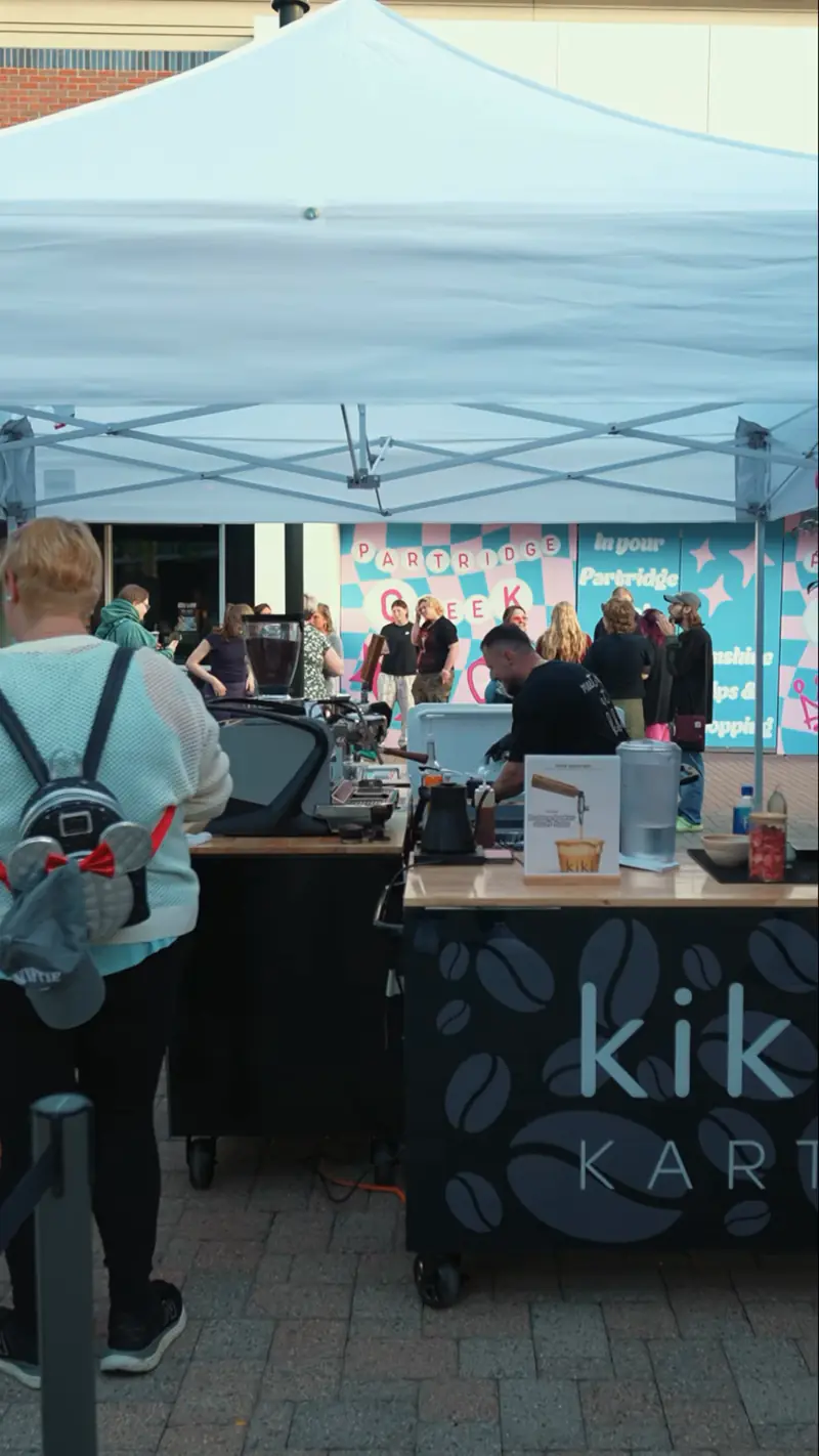 Kiki Kart coffee cart tent with guests at an outdoor concert at The Mall at Partridge Creek