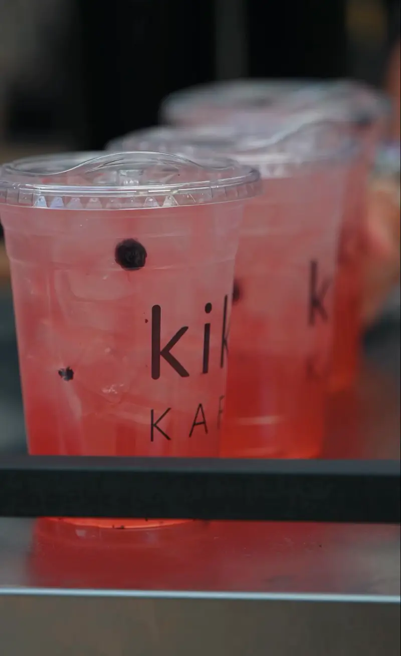 Pink refreshers lined up in Kiki Kafé cups at the Kiki Kart